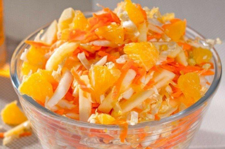 Salad with fresh cabbage, carrots and oranges Salad with fresh cabbage, carrots and oranges