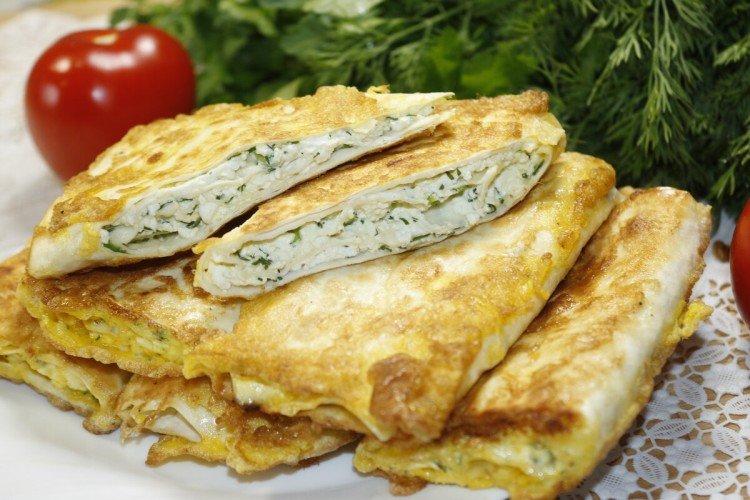 Lavash pies with cottage cheese and herbs in a pan Lavash pies with cottage cheese and herbs in a pan